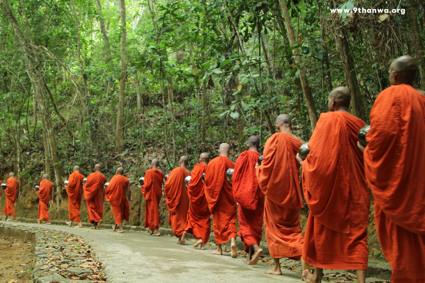 Monks walking for alms in the morning light